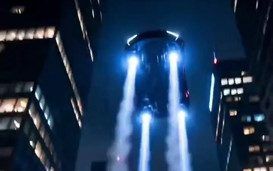 Skyline Flight: Your car flies between skyscrapers above a city at night
